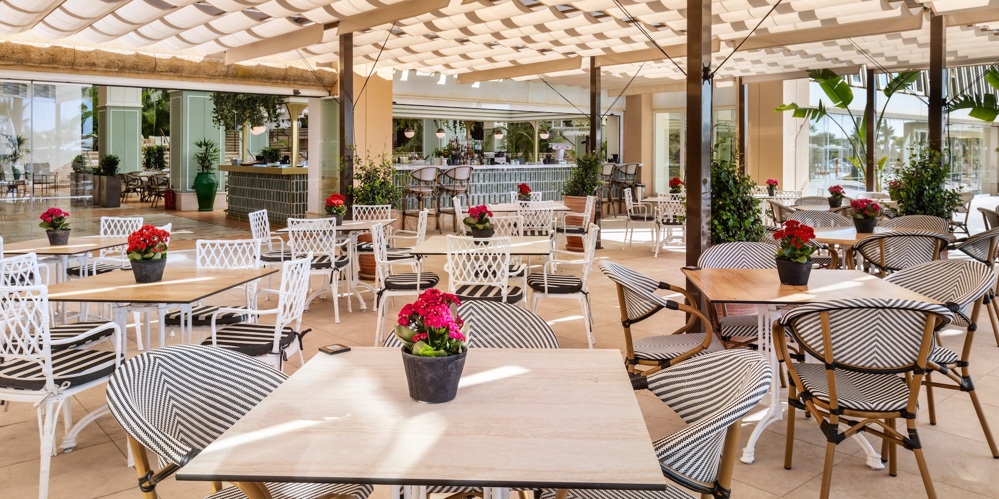 a patio with tables and chairs