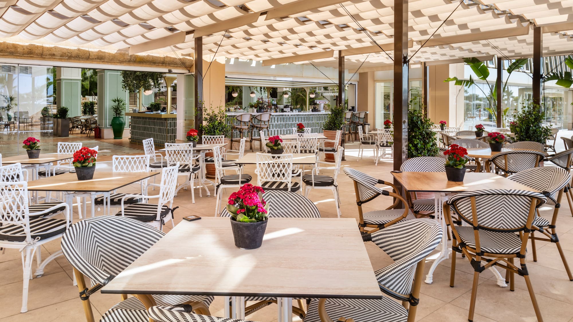 a patio with tables and chairs