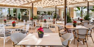 a patio with tables and chairs