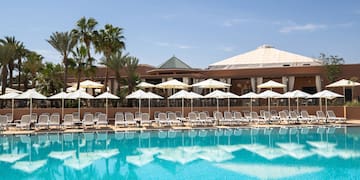 a pool with umbrellas and chairs