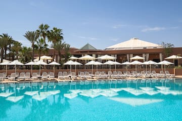 a pool with umbrellas and chairs