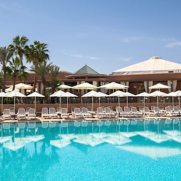 a pool with umbrellas and chairs