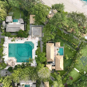 aerial view of a resort with a pool and a beach