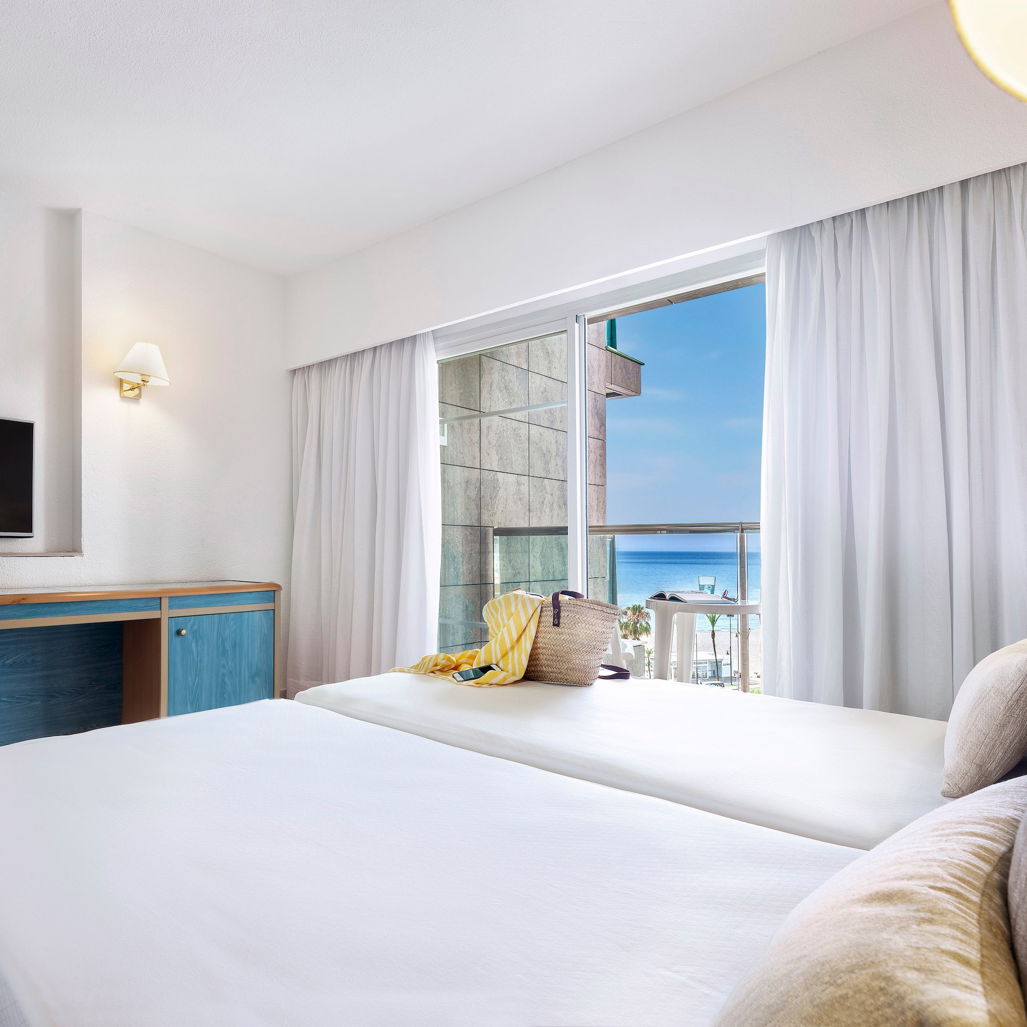 a room with a bed and a television