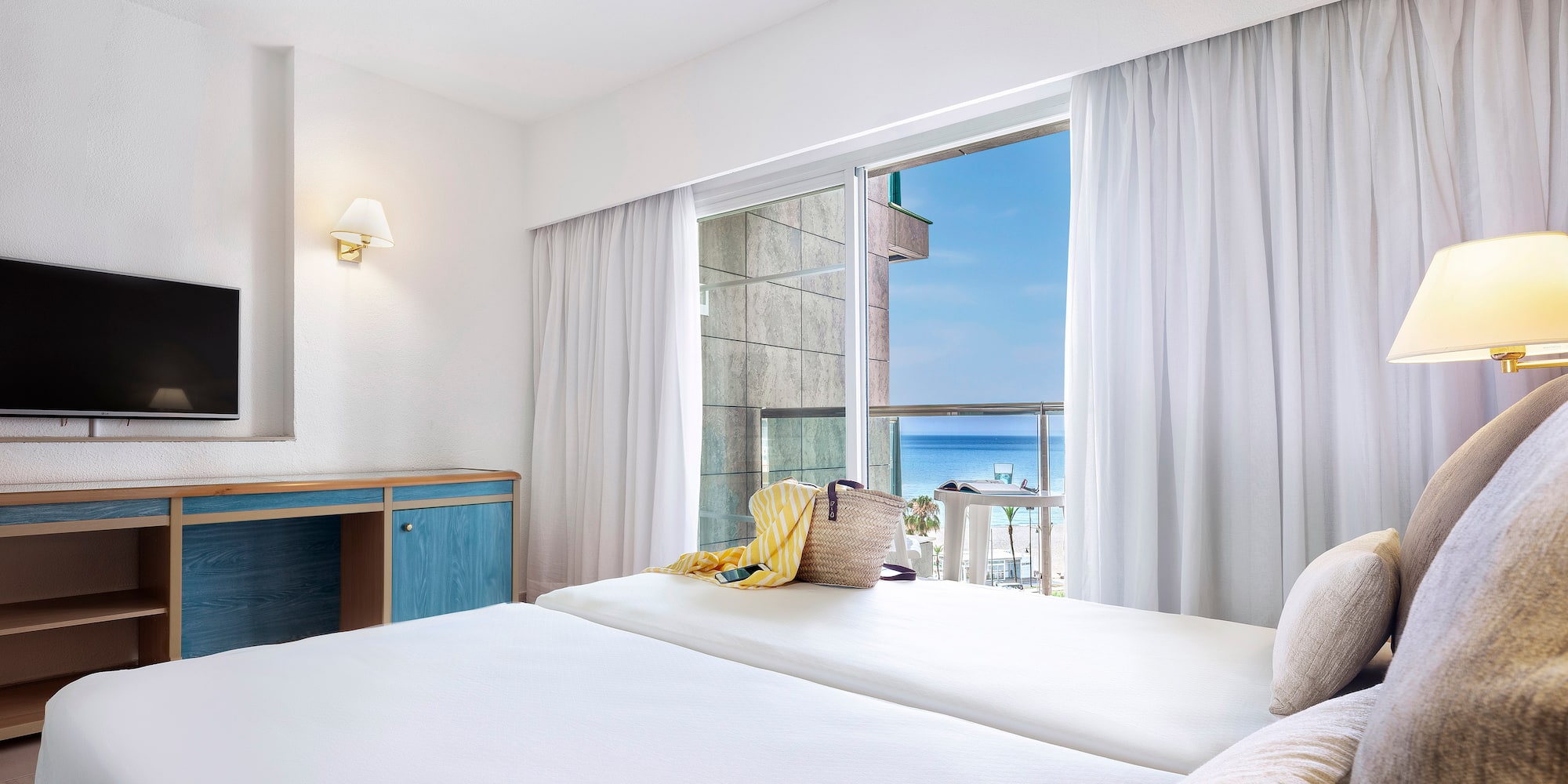 a room with a bed and a television