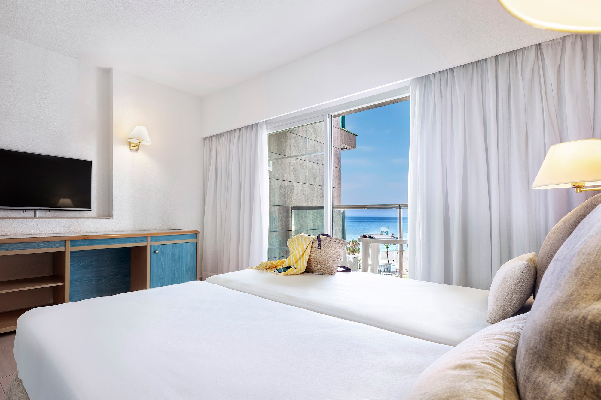 a room with a bed and a television