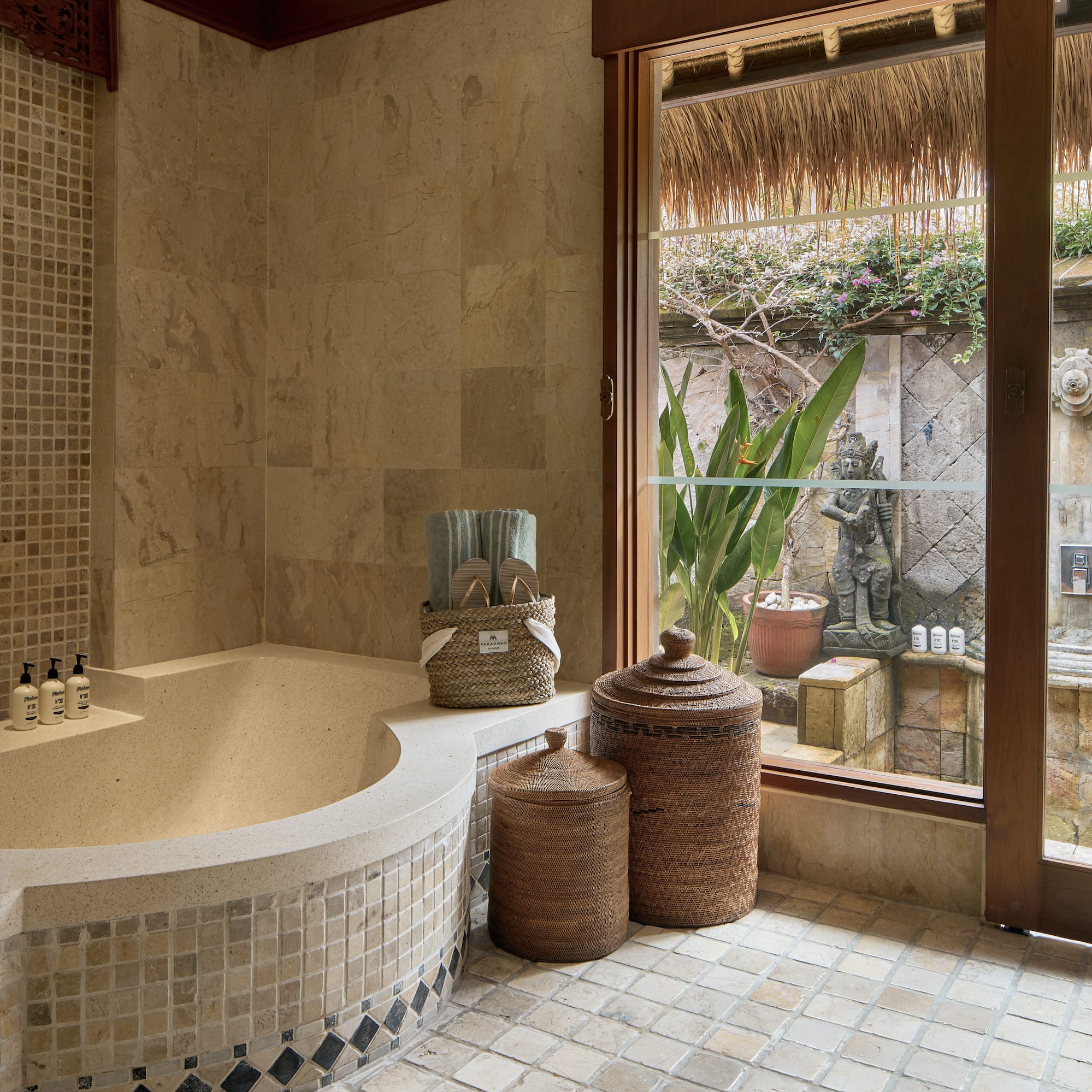 a bathroom with a tub and a glass door