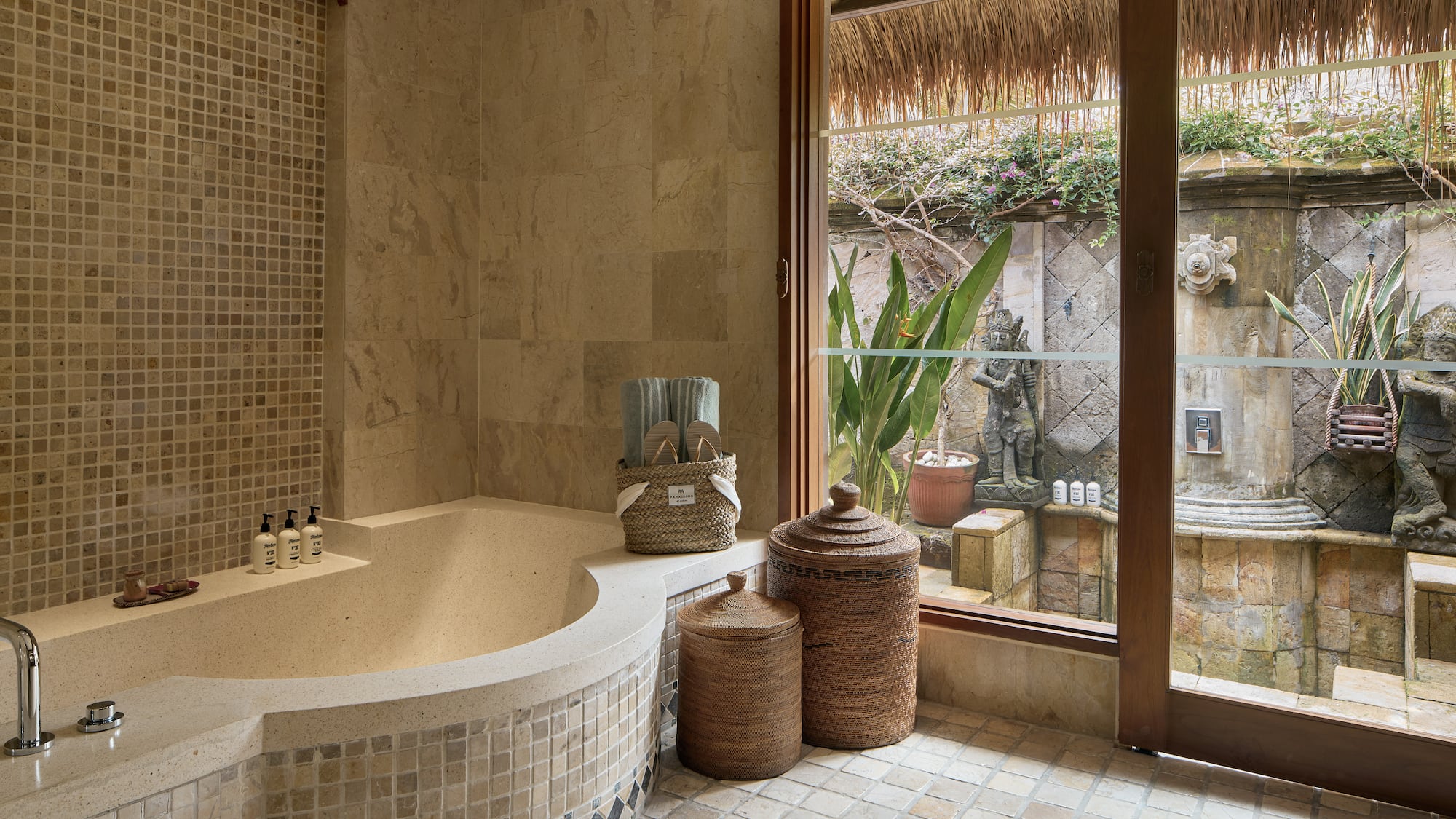 a bathroom with a tub and a glass door
