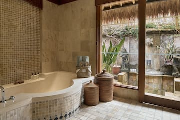 a bathroom with a tub and a glass door