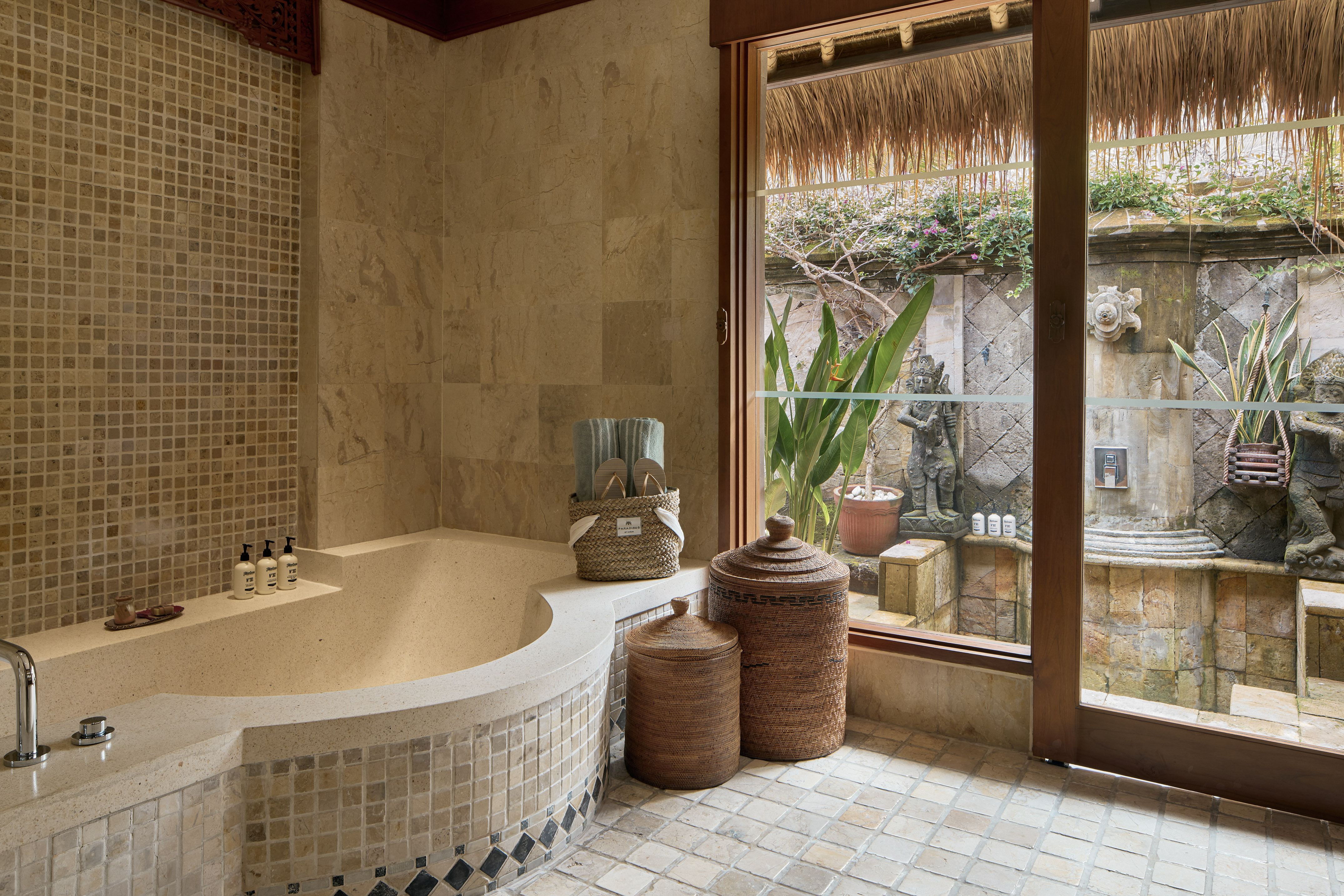 a bathroom with a tub and a glass door