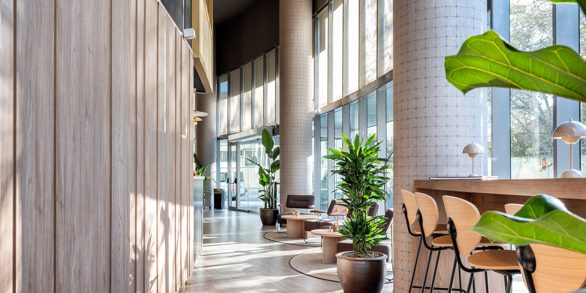 a room with a tall wall and a tall window