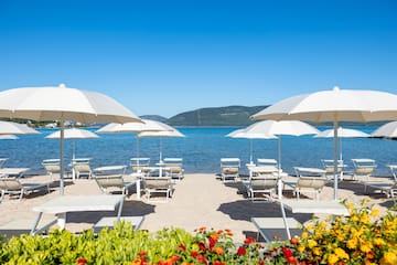 a beach with chairs and umbrellas