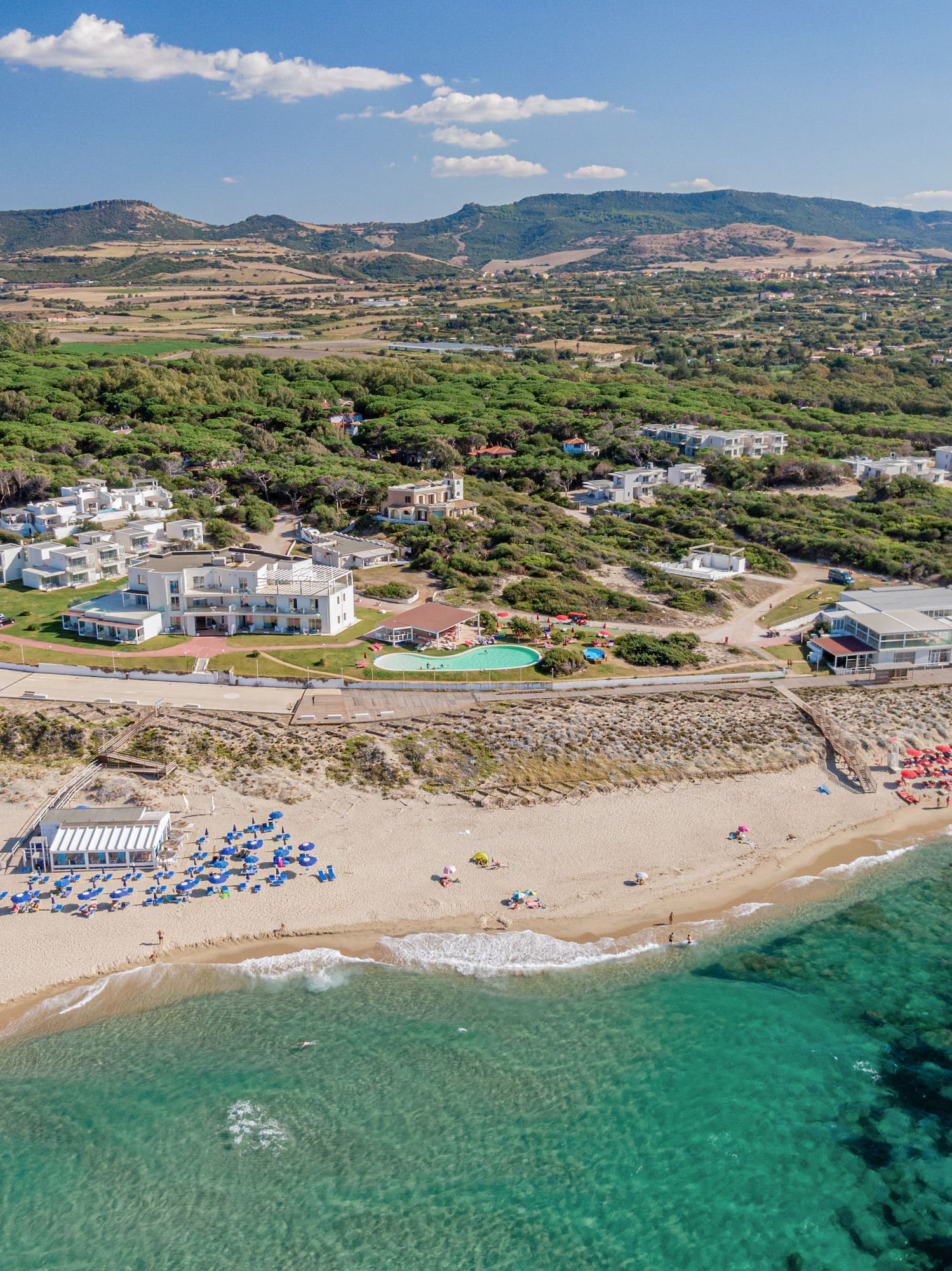 a beach with buildings and a body of water
