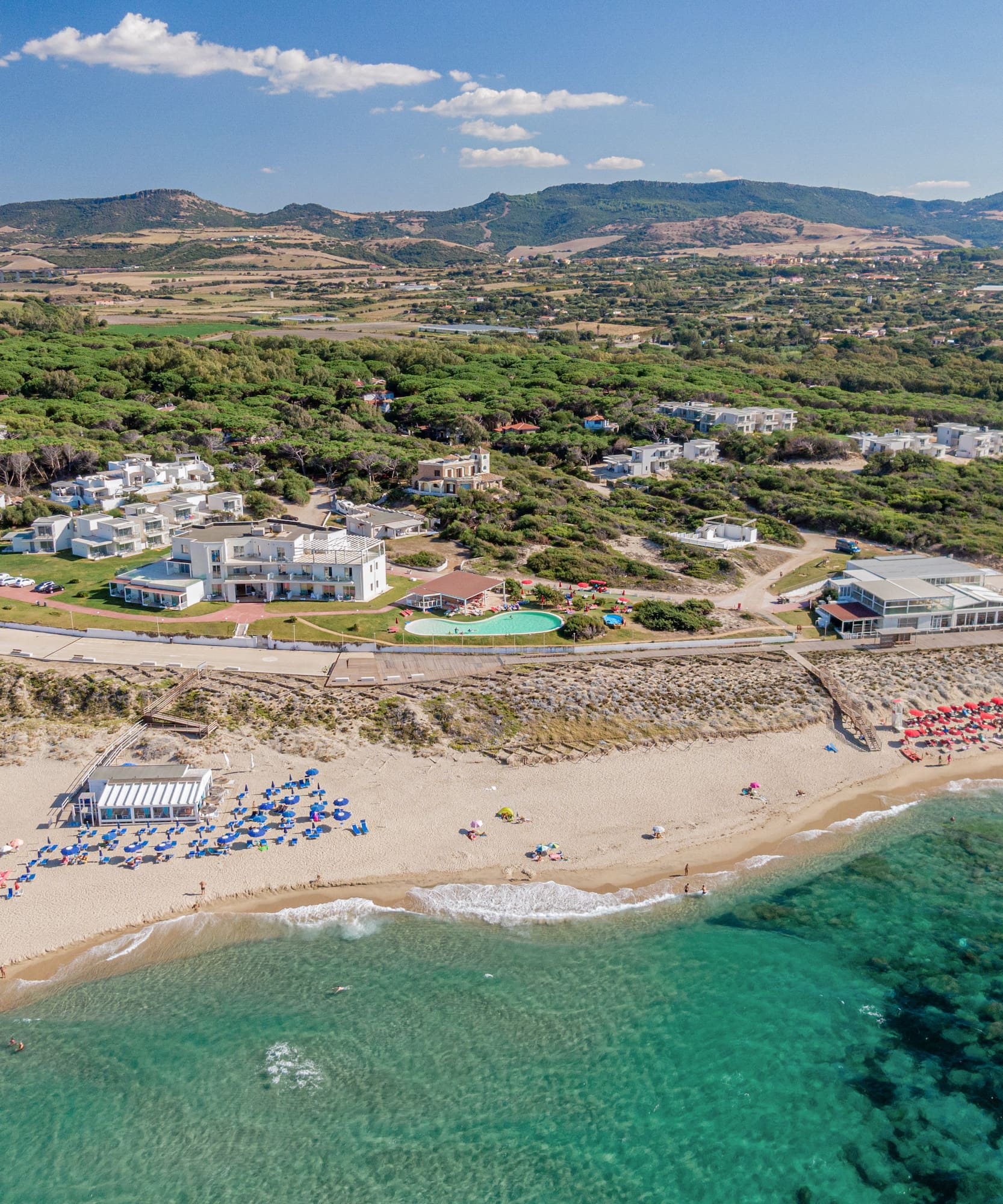 a beach with buildings and a body of water