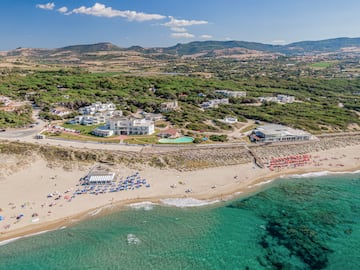 a beach with buildings and a body of water