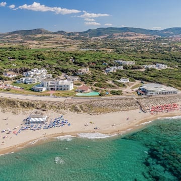 a beach with buildings and a body of water