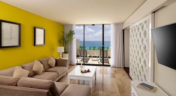 a living room with a yellow wall and a couch