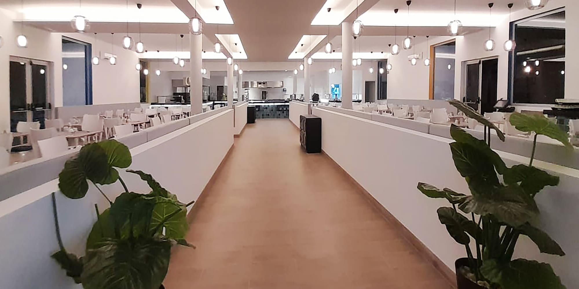 a hallway with lights and tables