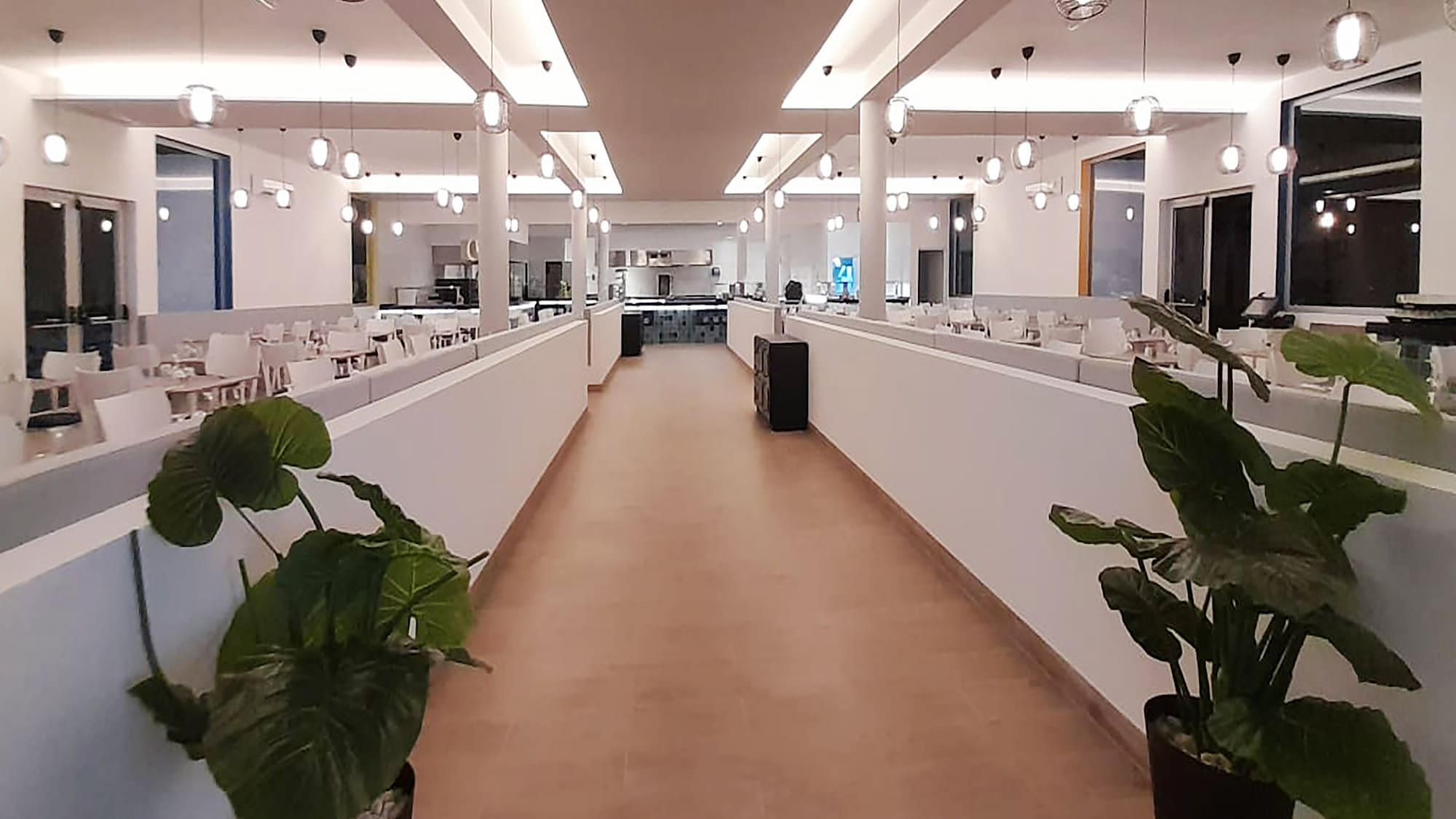 a hallway with lights and tables