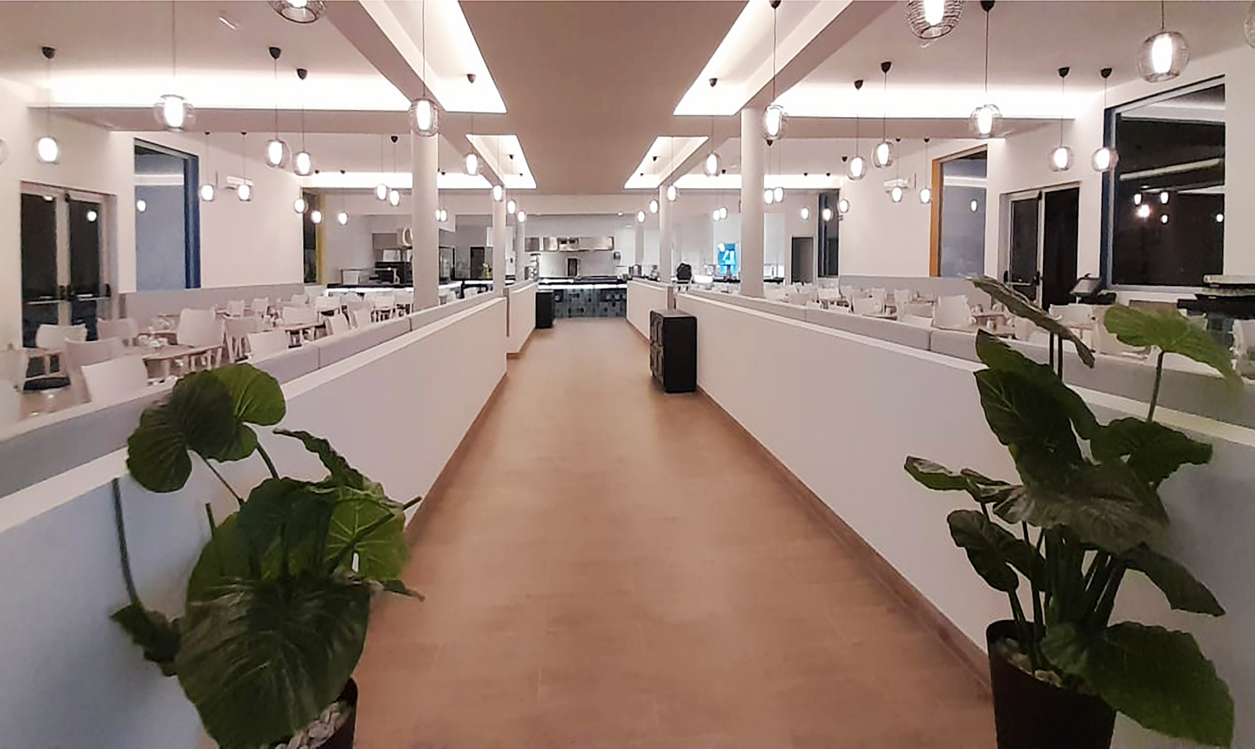 a hallway with lights and tables