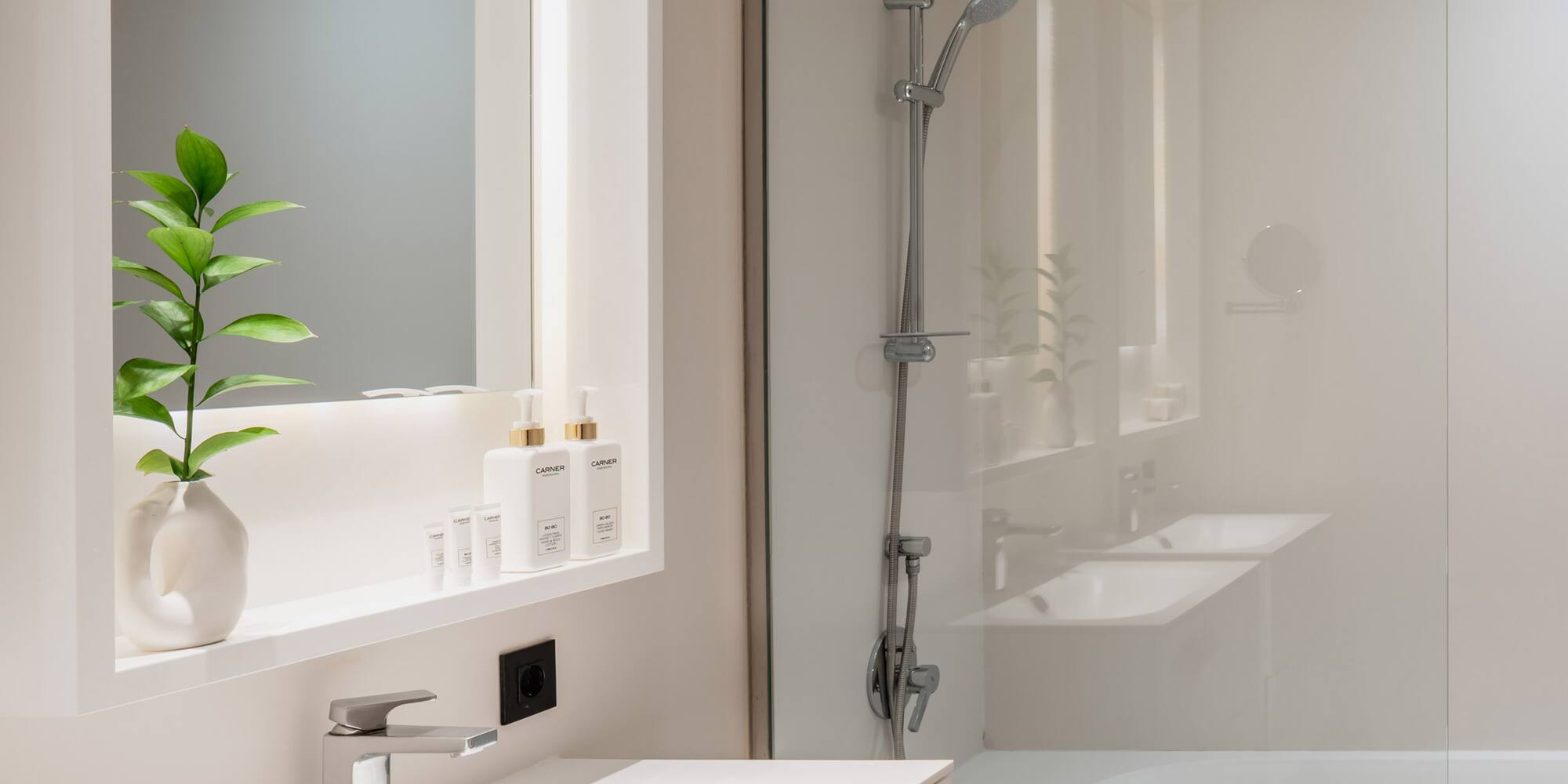 a bathroom with a glass shower and sink