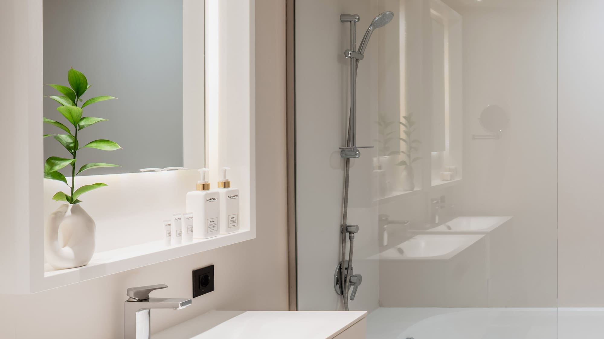 a bathroom with a glass shower and sink