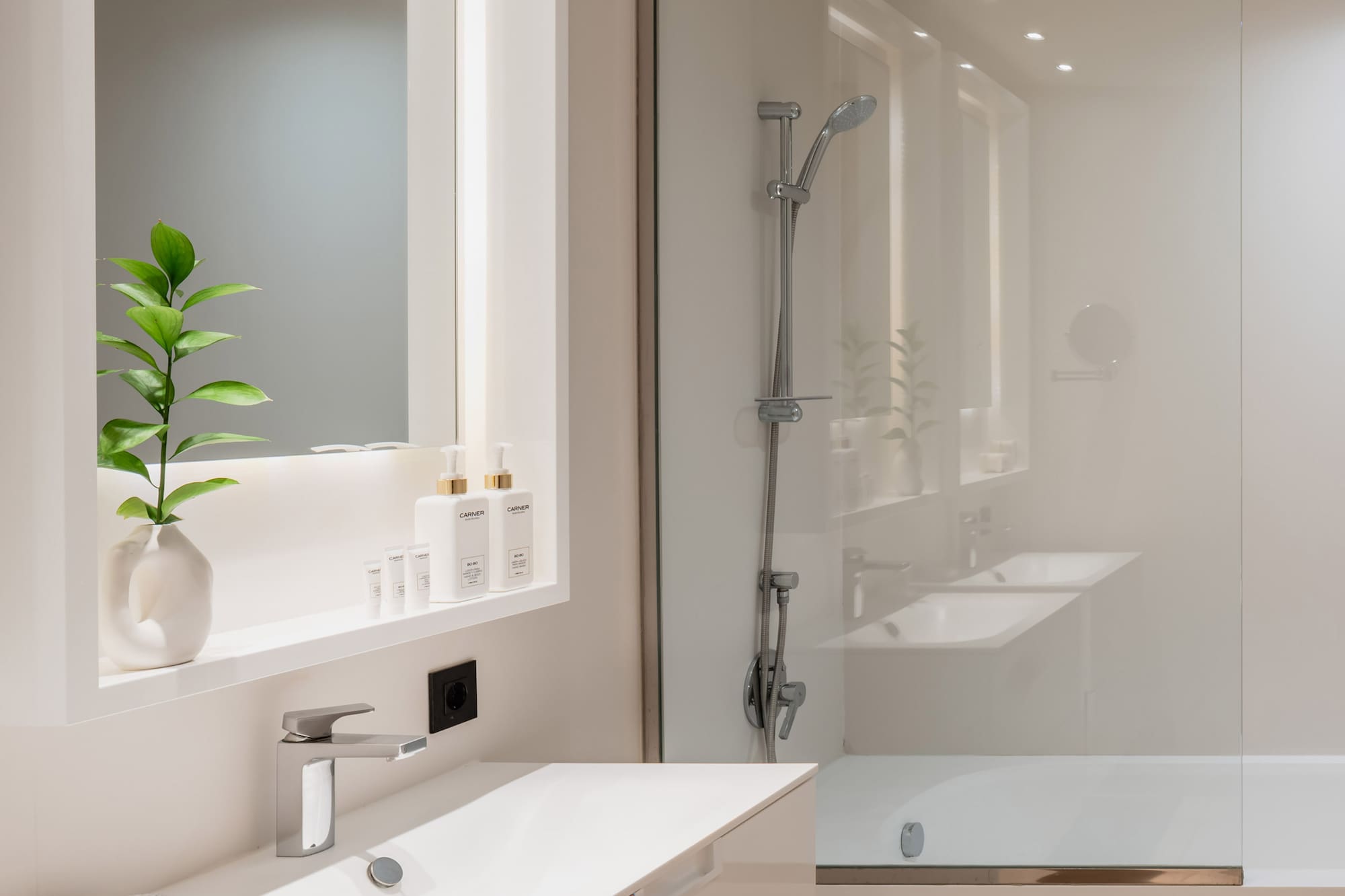 a bathroom with a glass shower and sink