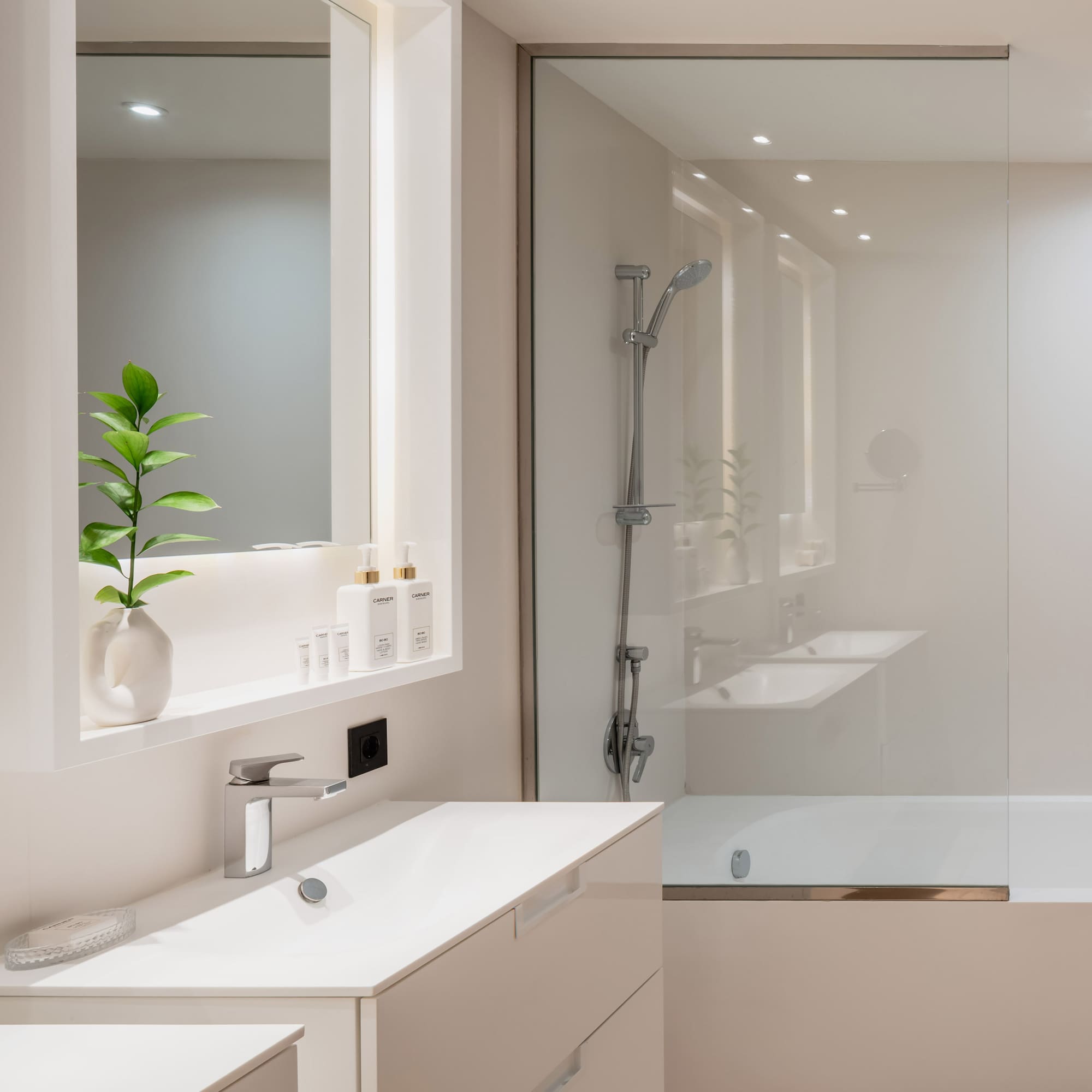 a bathroom with a glass shower and sink