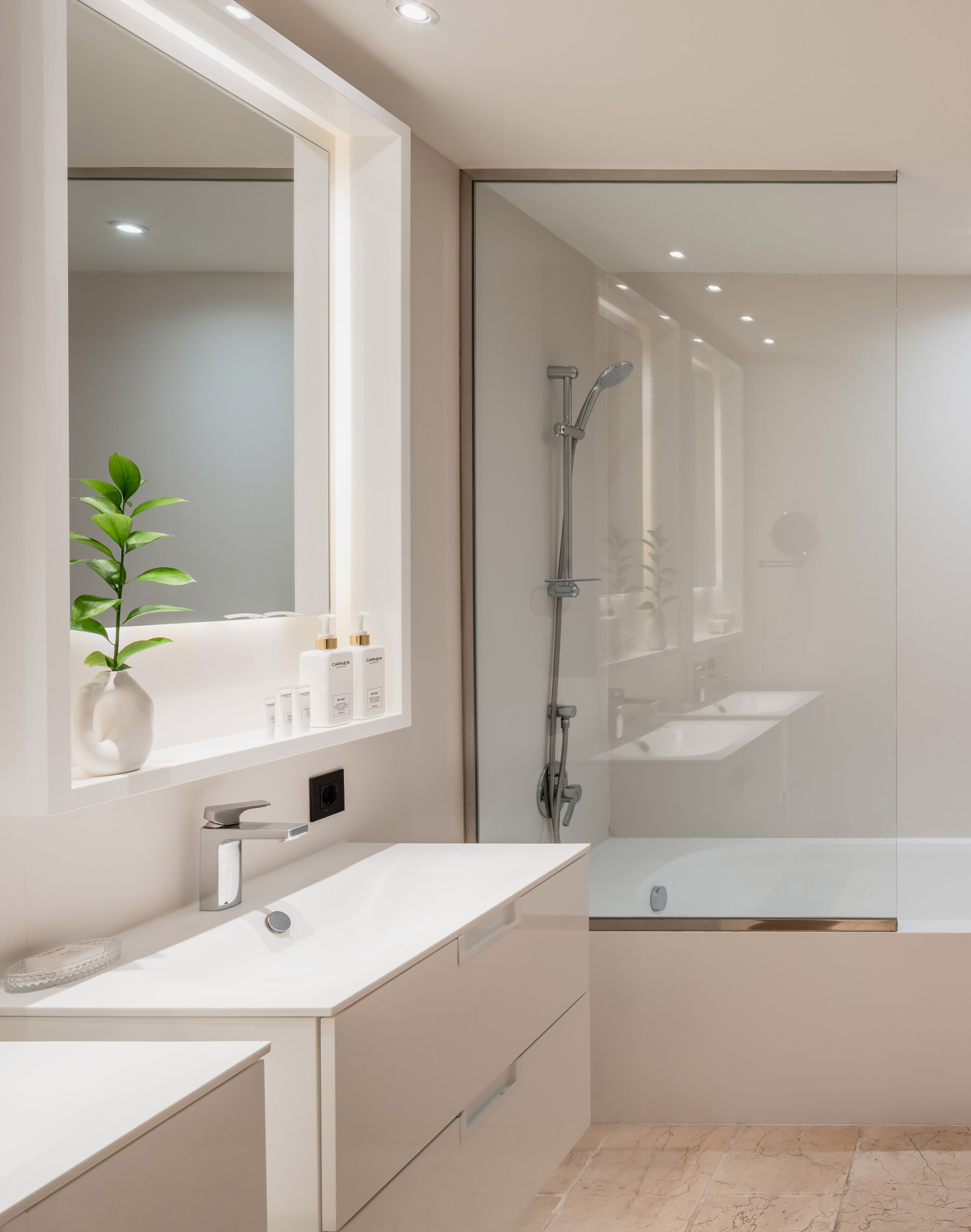 a bathroom with a glass shower and sink