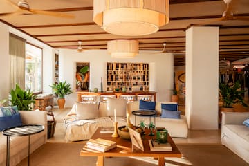 a living room with a large table and chairs