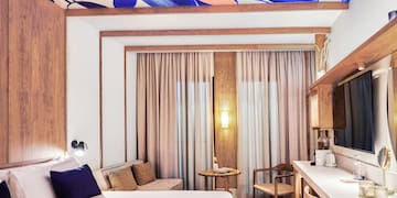 a room with a bed and a table and chairs