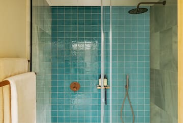 a shower with a shower head and a shower head