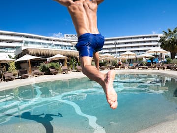 a man jumping into a pool