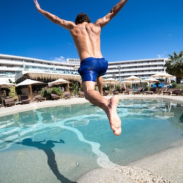 a man jumping into a pool