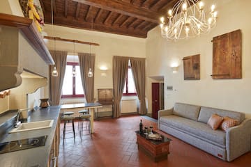 a living room with a couch and a kitchen