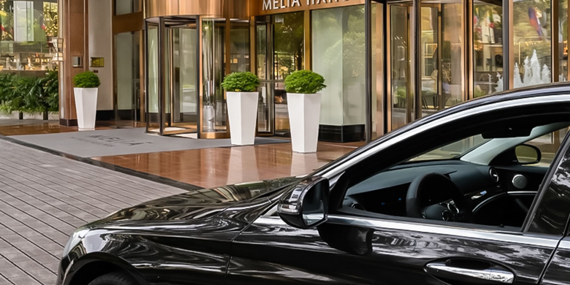 a black car parked outside of a building