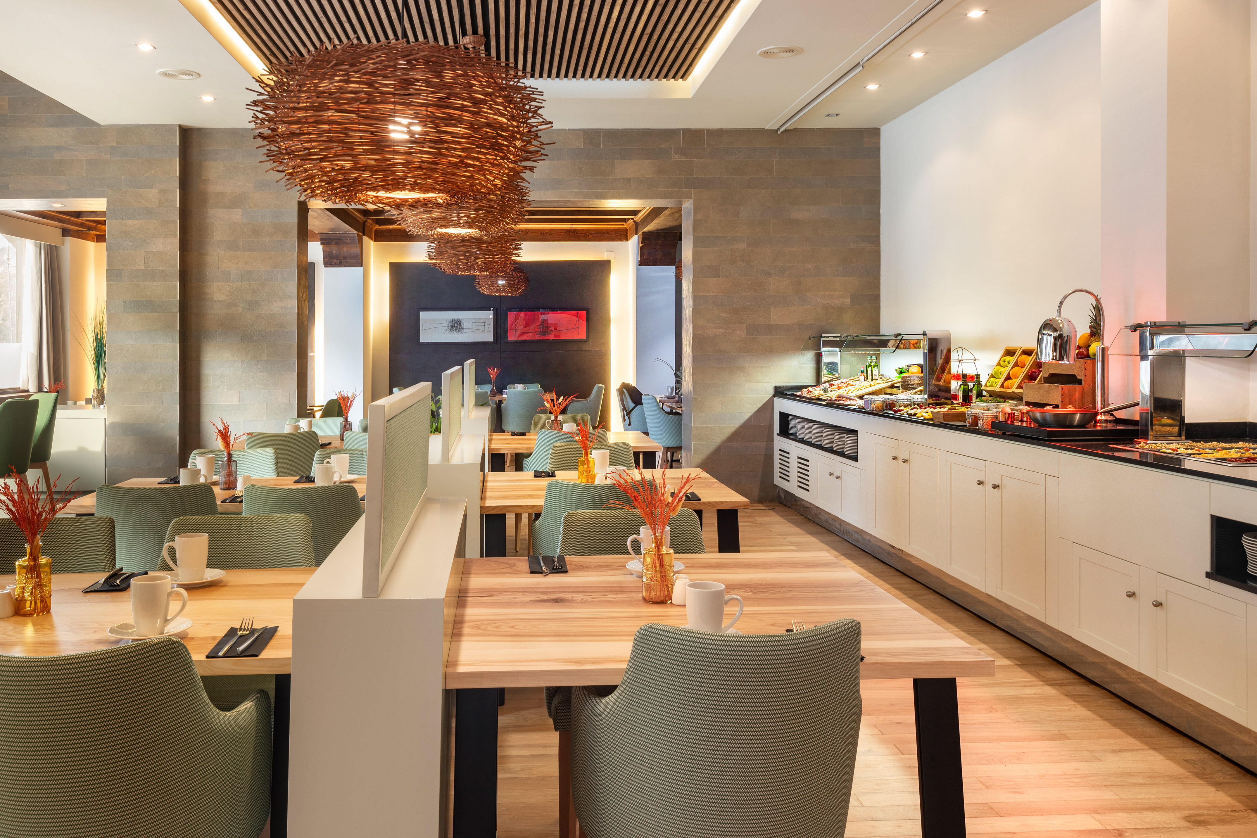 Modern hotel restaurant with breakfast buffet and contemporary decor.