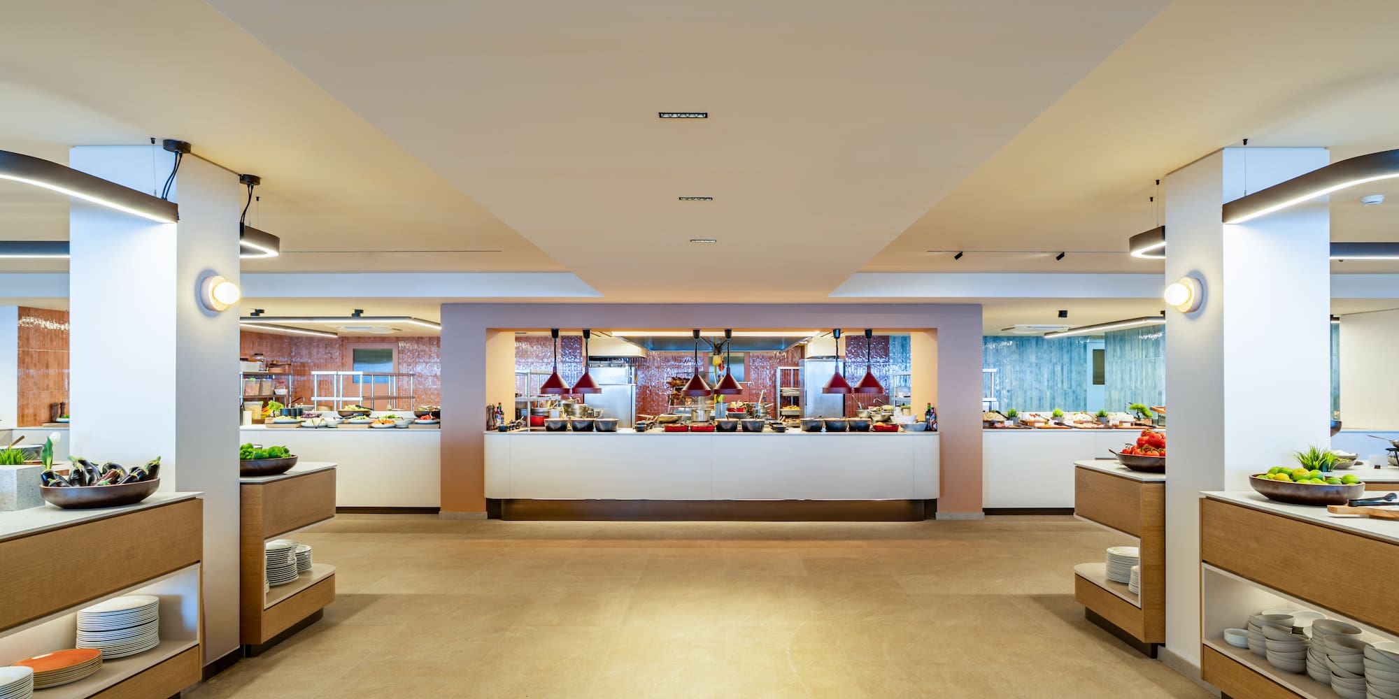 Modern hotel buffet setup with various food stations and fresh ingredients.