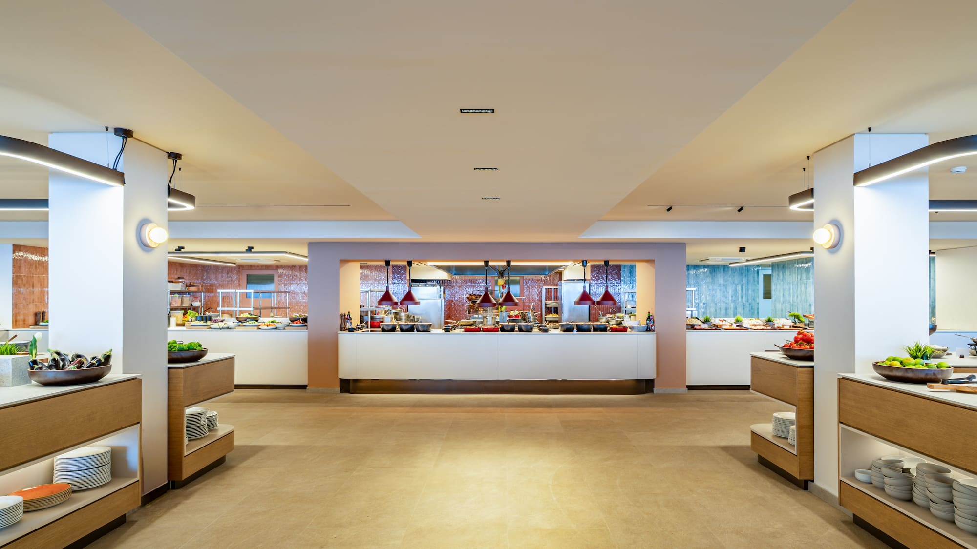 Modern hotel buffet setup with various food stations and fresh ingredients.