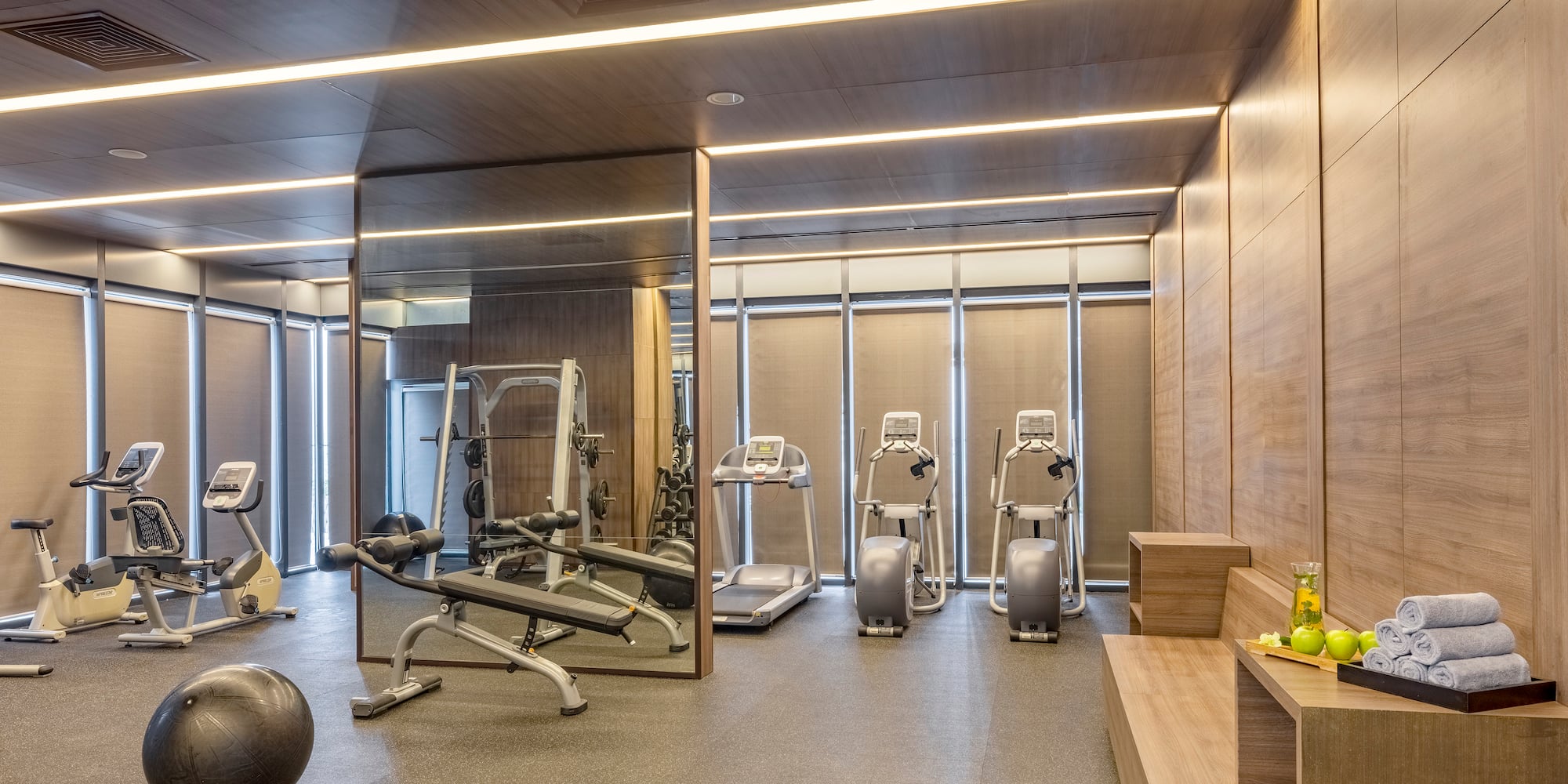 a room with exercise equipment and a mirror