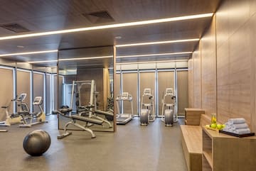 a room with exercise equipment and a mirror