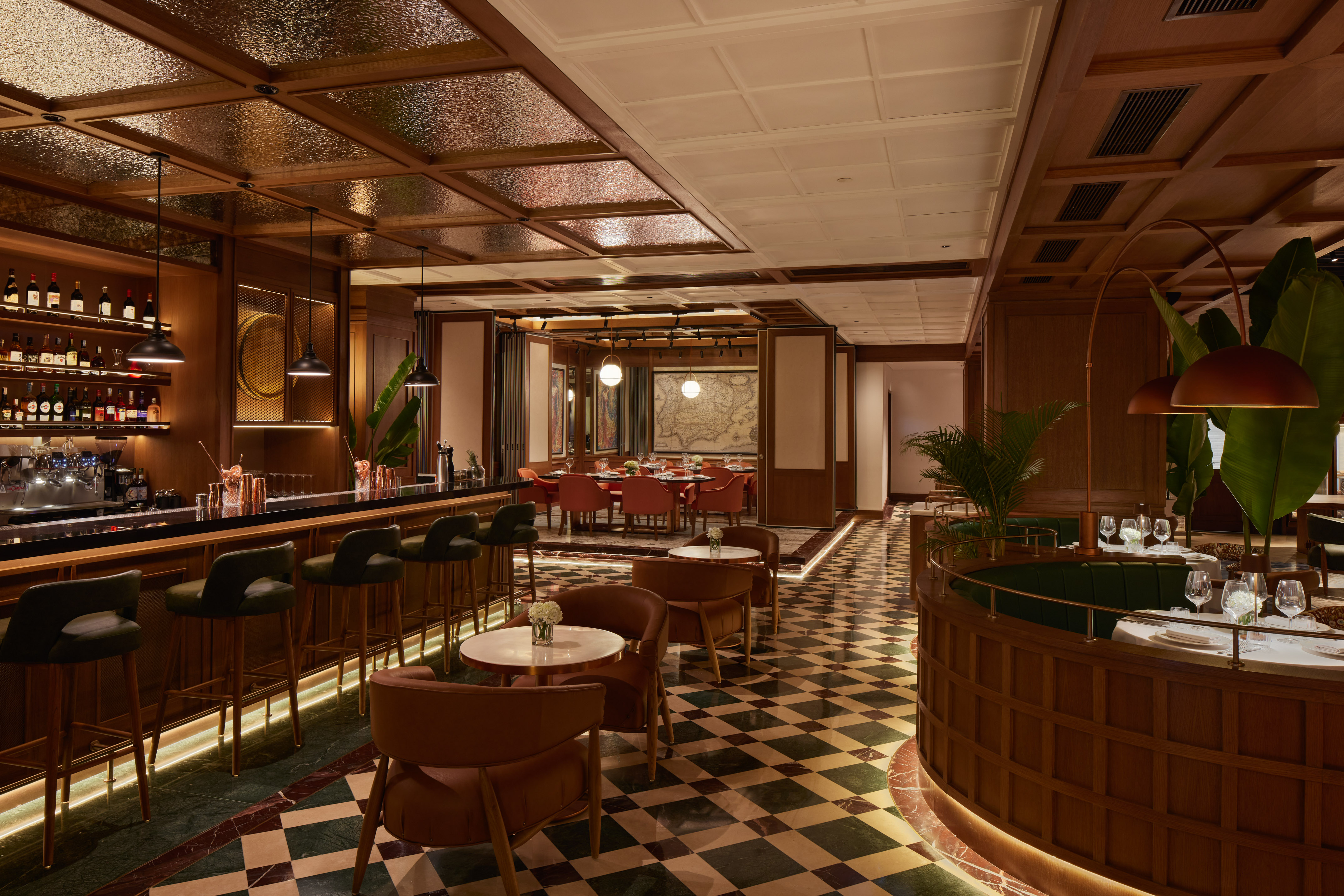 Elegant restaurant bar with dark wood, checkered marble floor, and cozy dining areas.