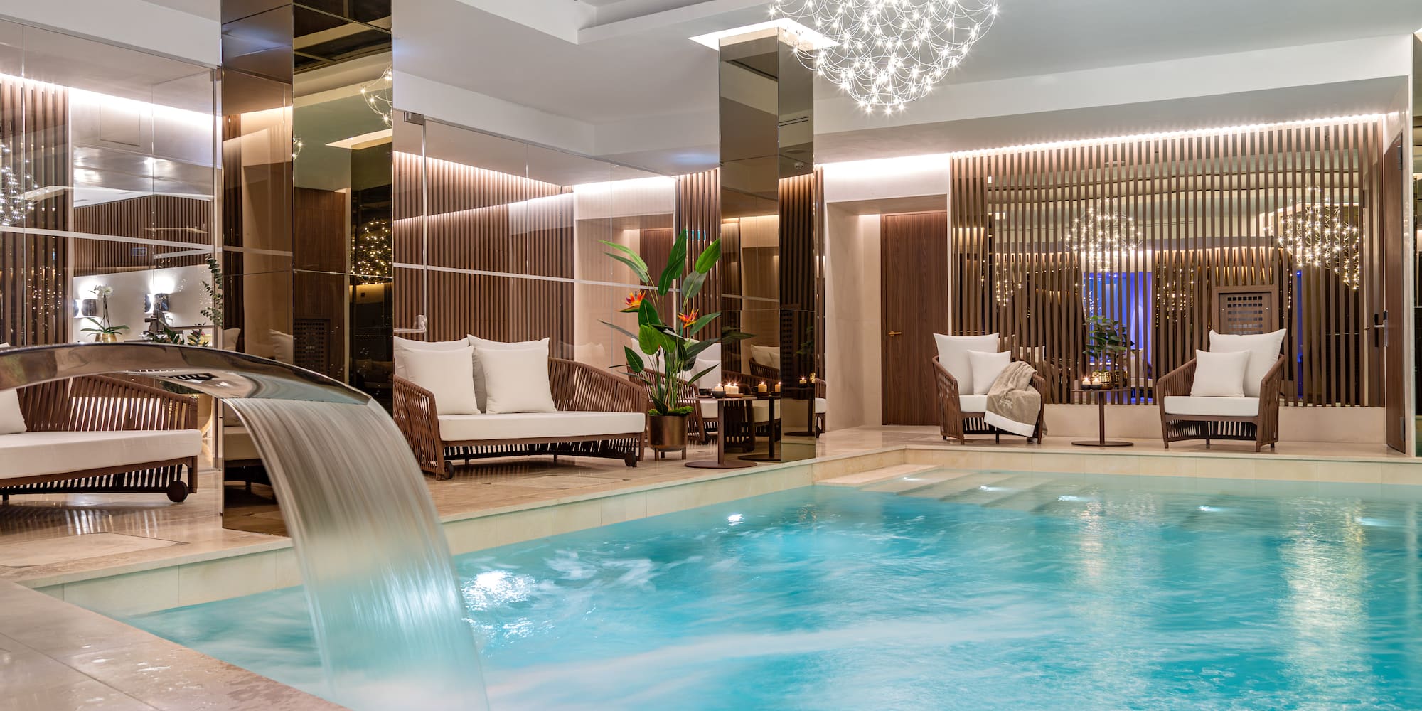 a pool with a waterfall in a room
