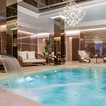 a pool with a waterfall in a room