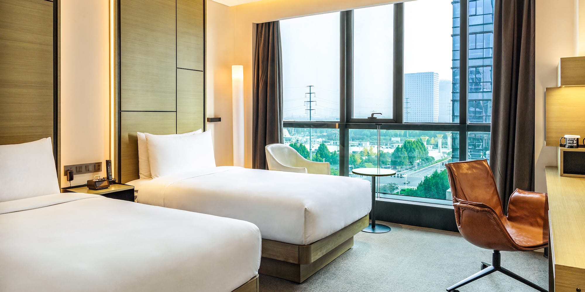 a hotel room with two beds and a chair