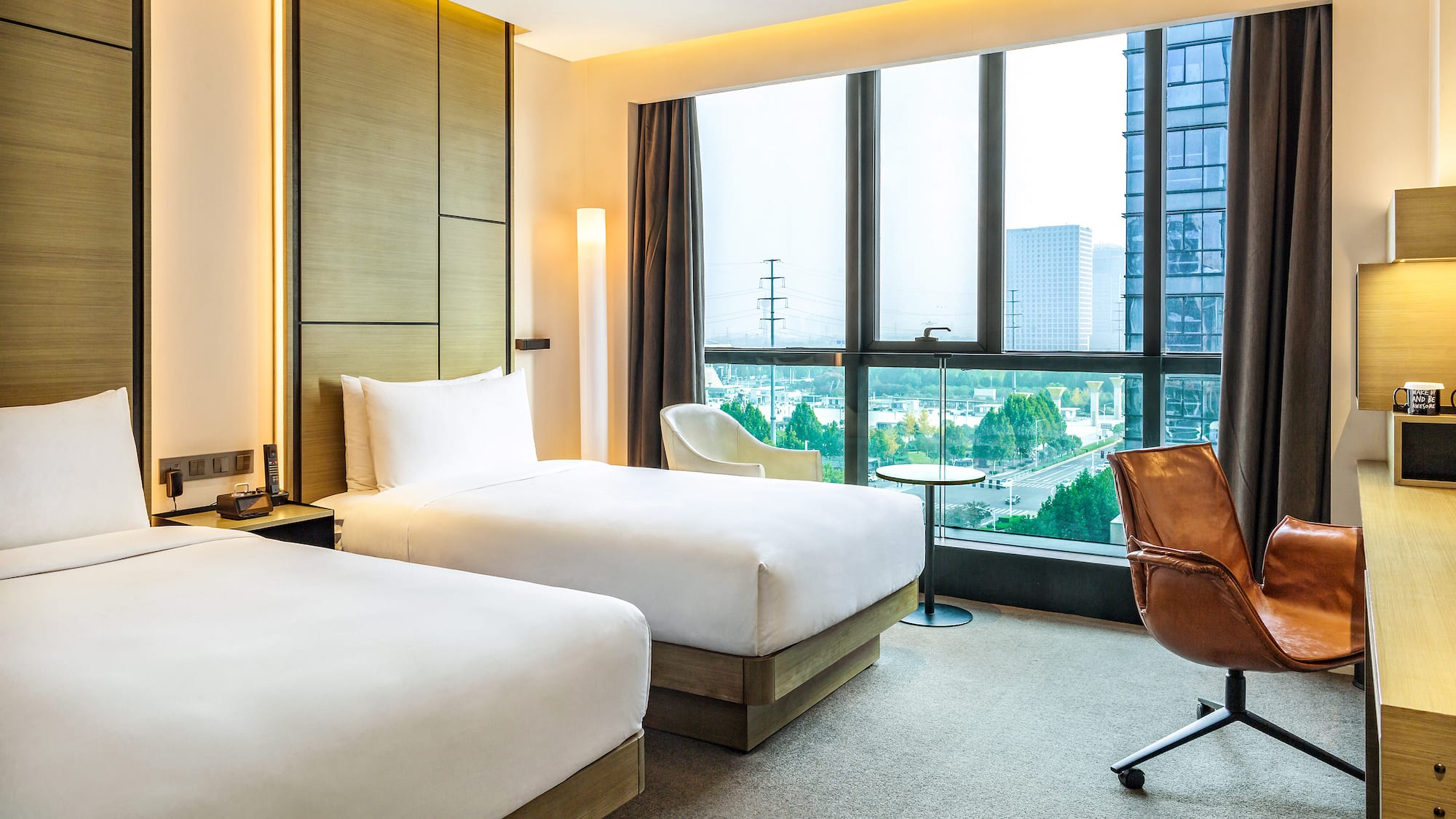 a hotel room with two beds and a chair