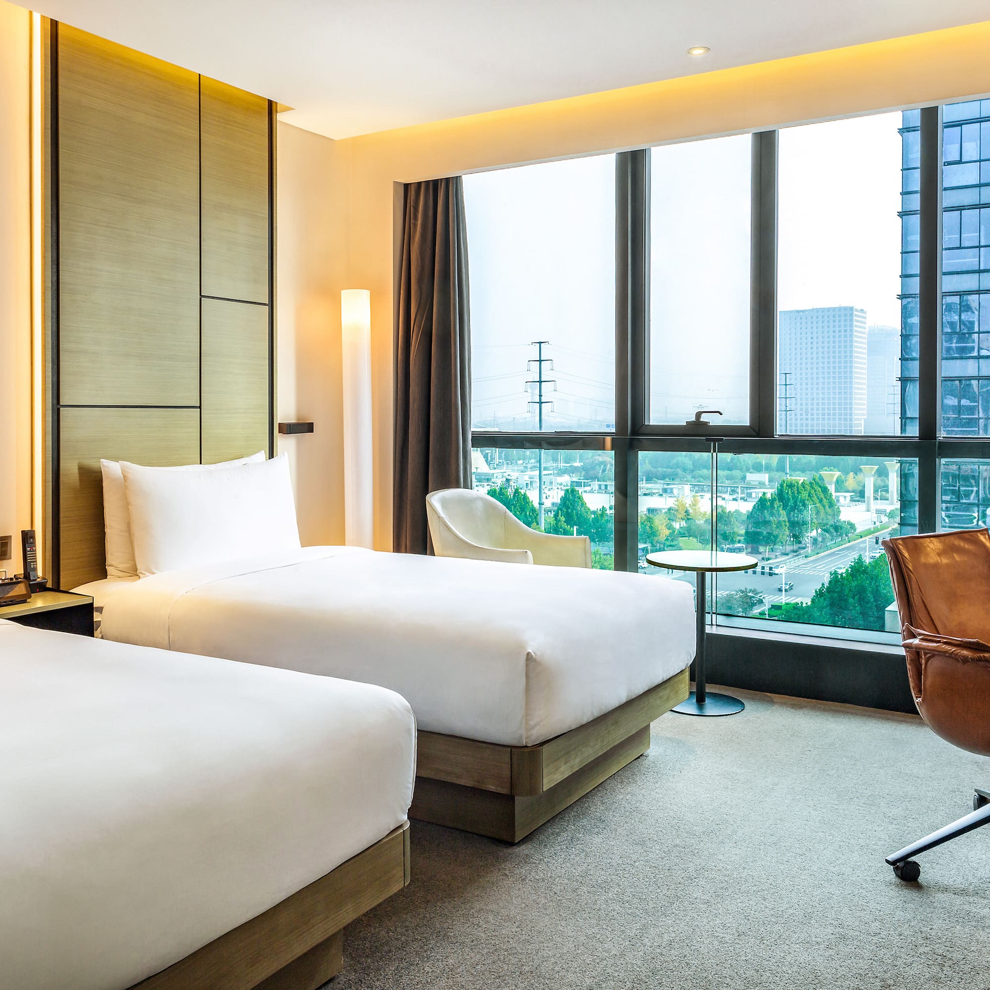 a hotel room with two beds and a chair