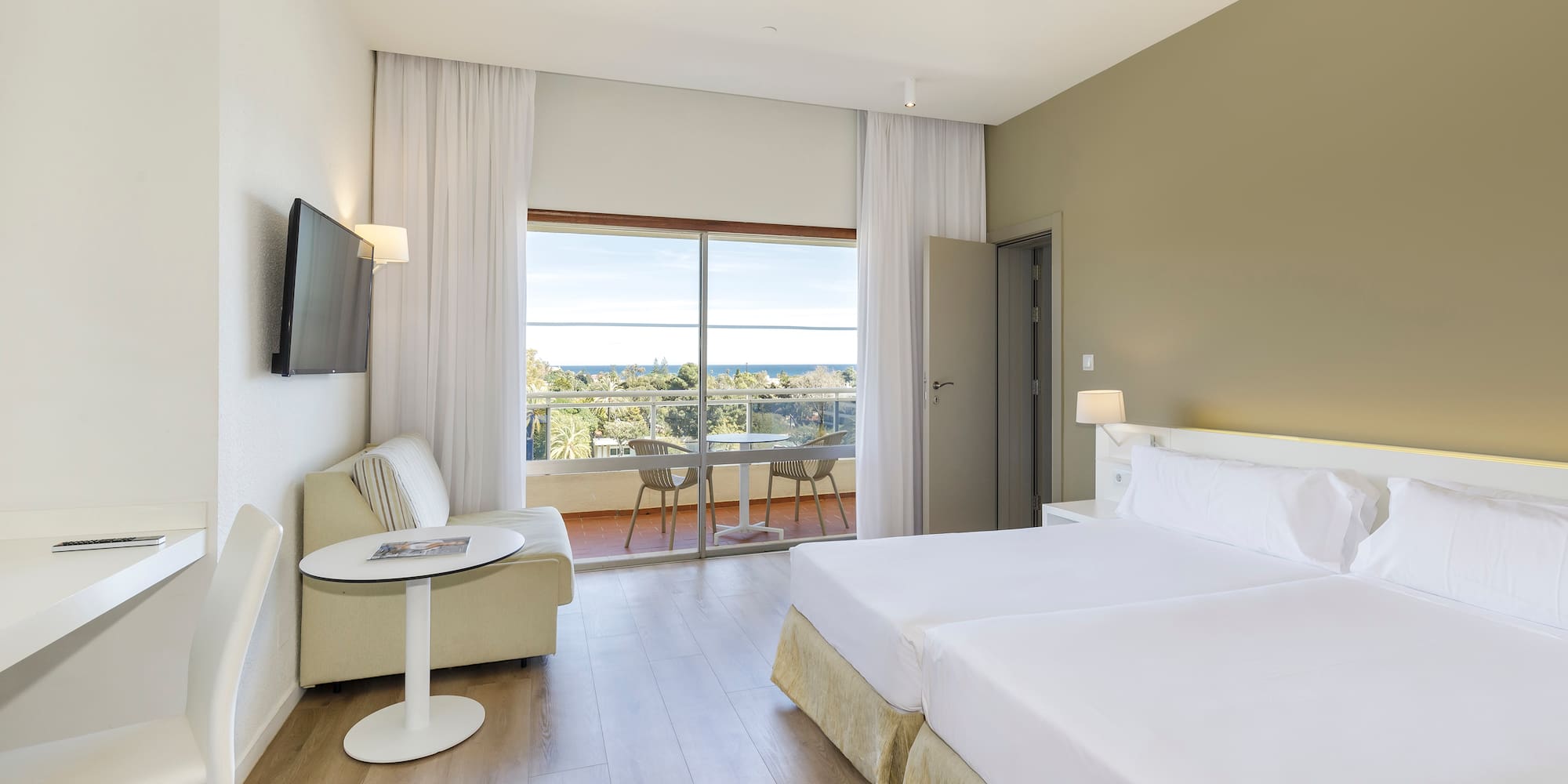 a room with two beds and a television