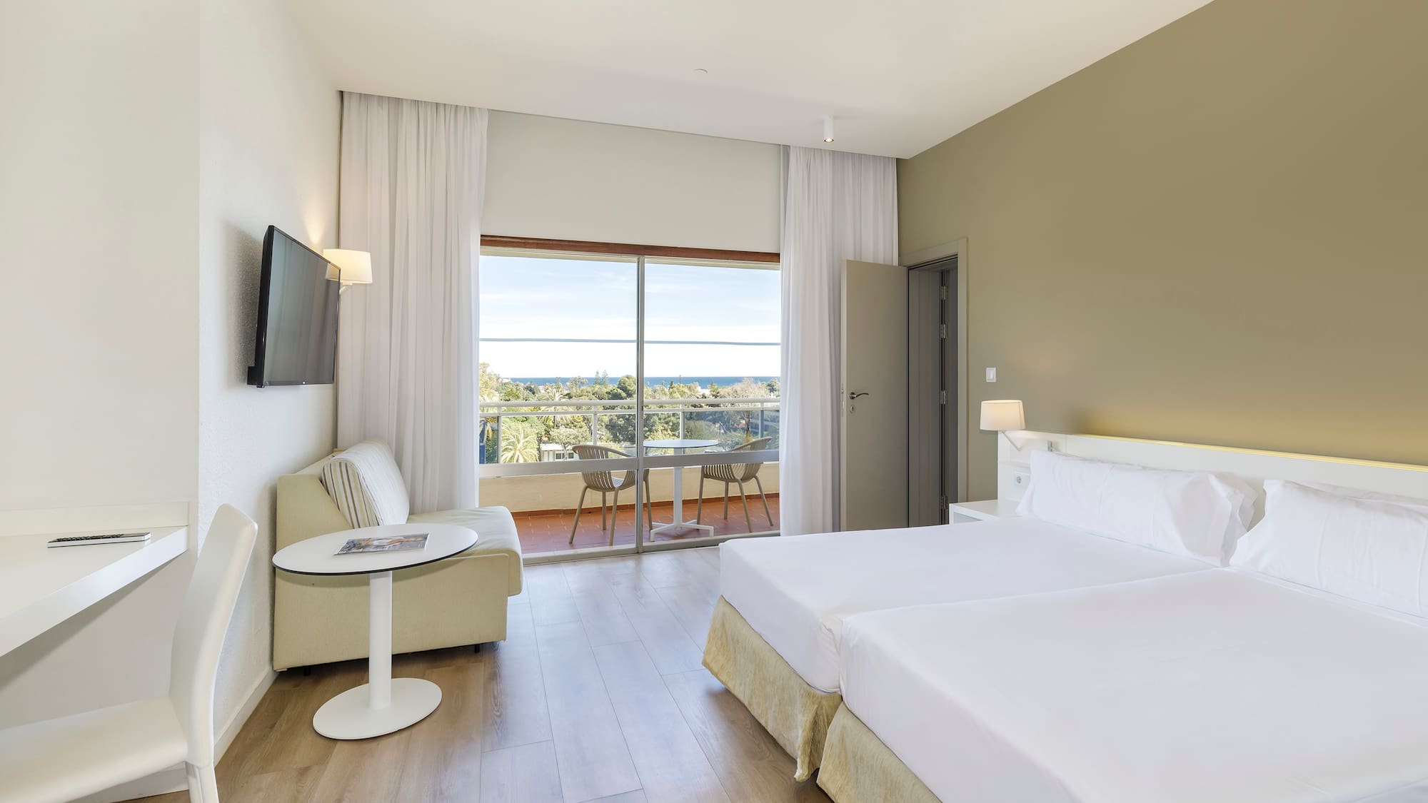 a room with two beds and a television