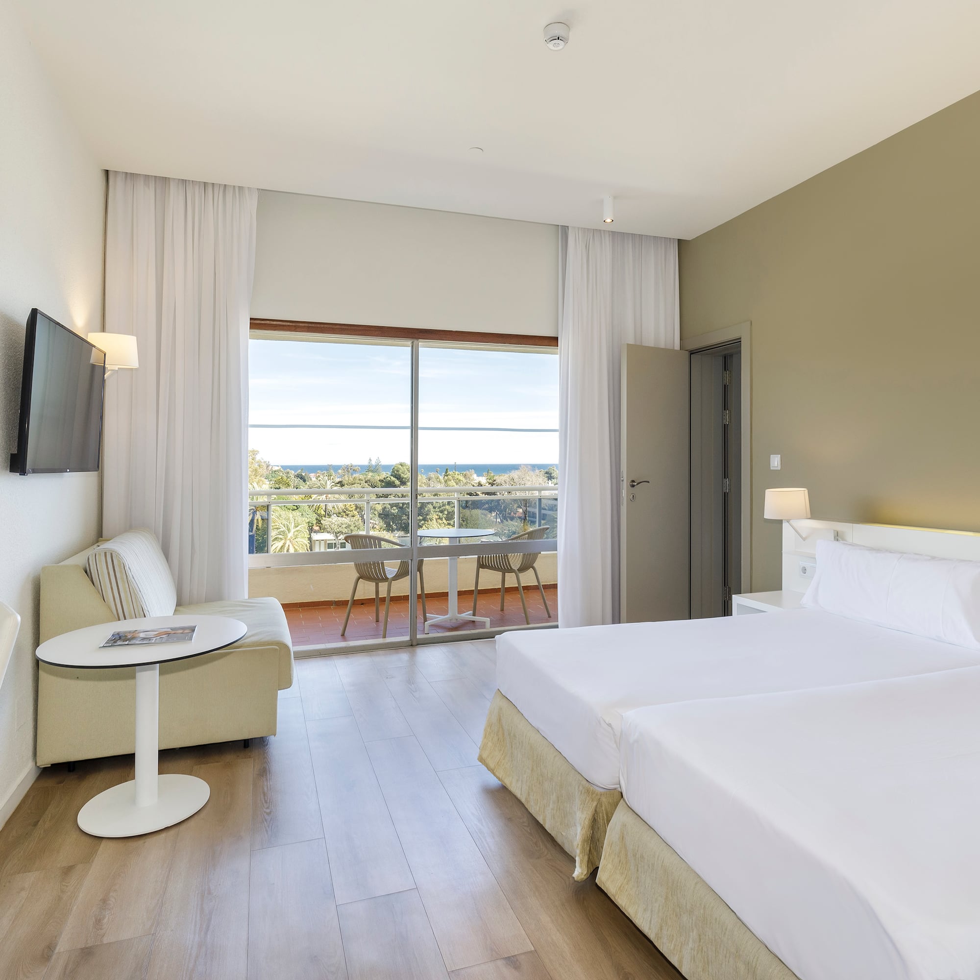 a room with two beds and a television